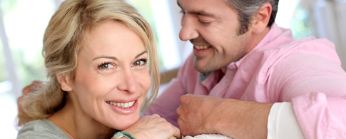 Mature male and female Greenwich couple smiling after dental visit